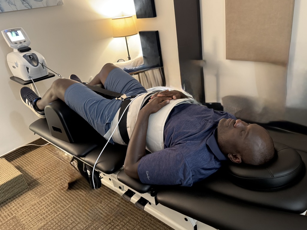 Dr. Jeff Manning providing non-surgical spinal decompression therapy at Manning Wellness Clinic in Dallas.